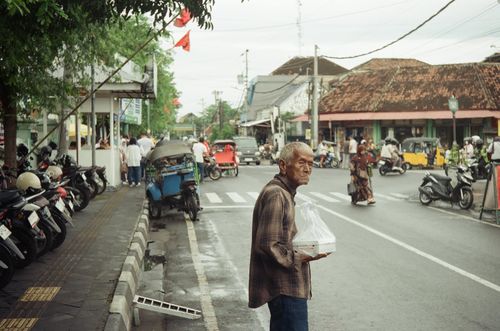 Man outside street market, Yogyakarta, Indonesia