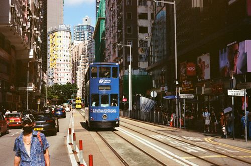 Tram, rounded building, from afar. Wan Chai, Hong Kong
