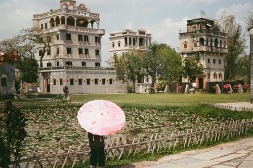 Diaolou cluster woman with umbrella, Kaiping, Guangdong, China